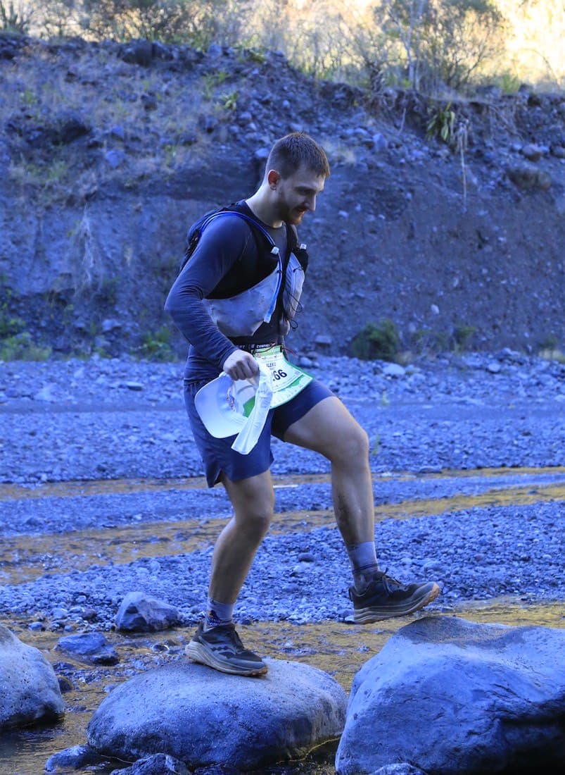 Alexis Raimbault, founder of EASYTECH, trail running in a mountain riverbed